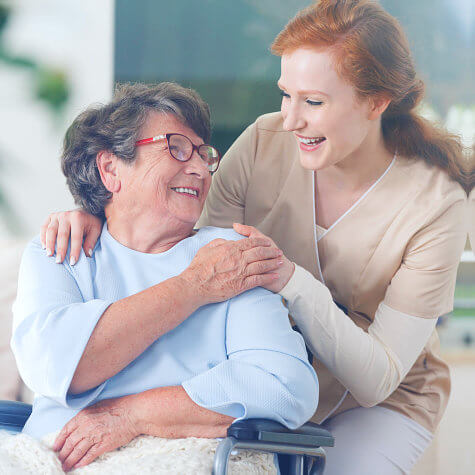 caregiver and an elderly woman having a good laugh