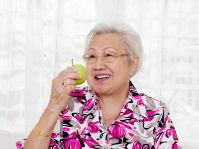senior woman eating apple